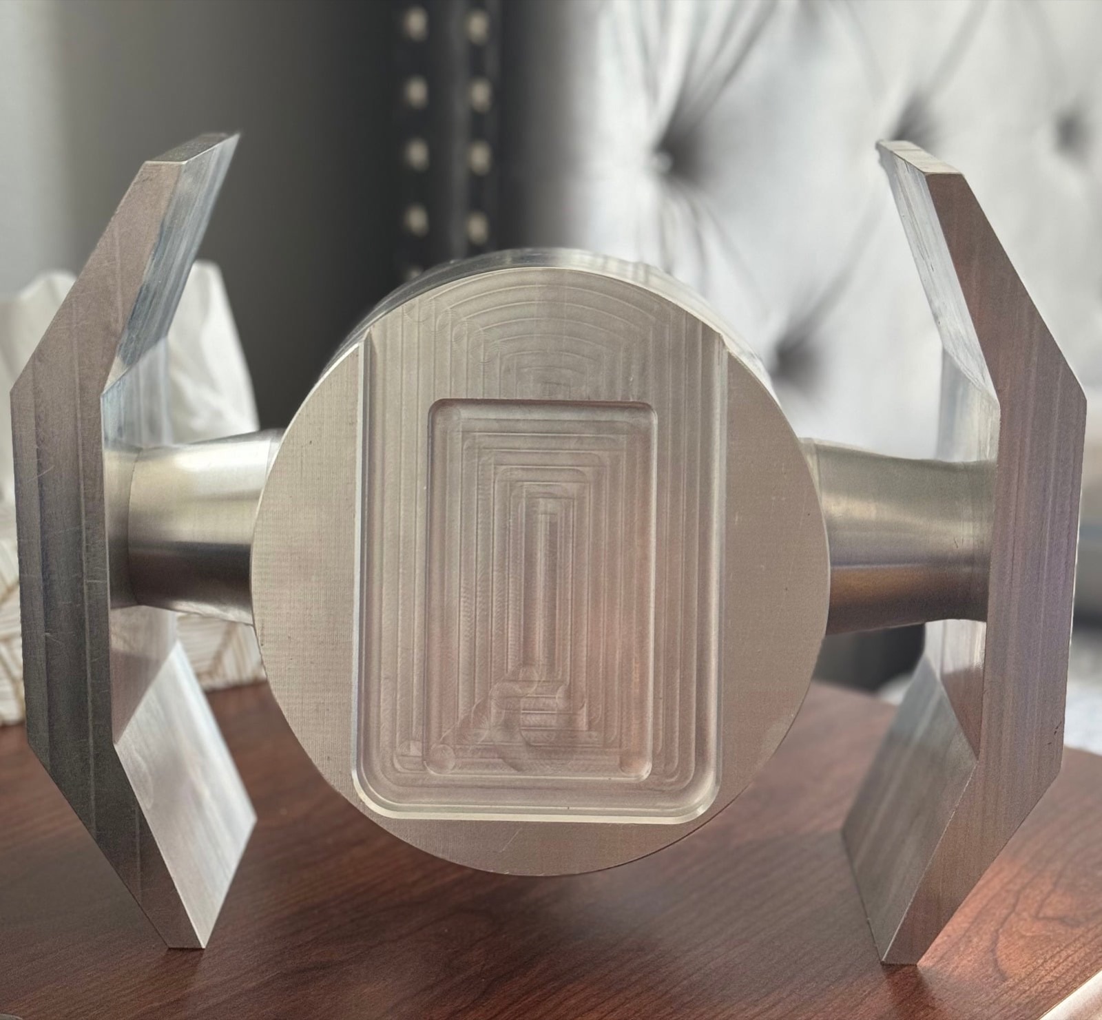 Finished charging stand machined from aluminum, a TIE fighter form with a recessed phone cradle