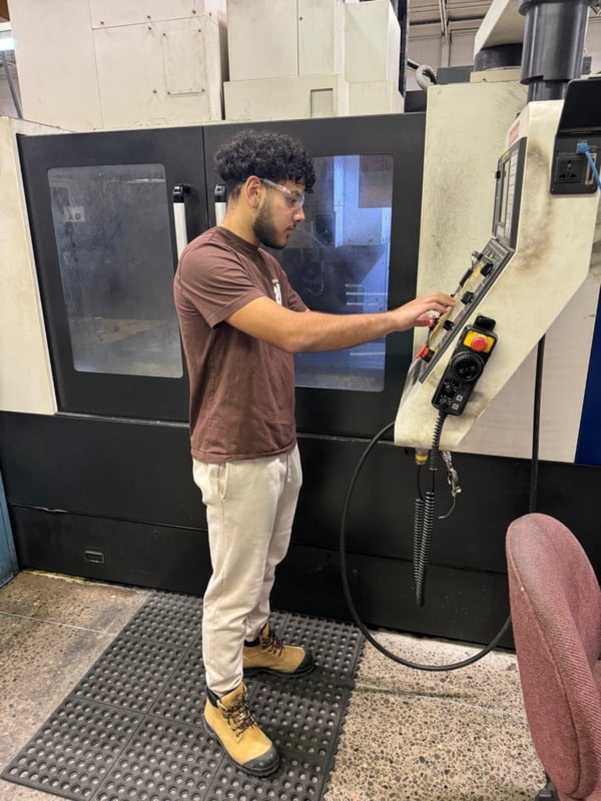 Michael operating a CNC milling machine at Multimatic